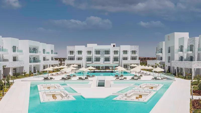 A Large Building With A Pool In Front Of It