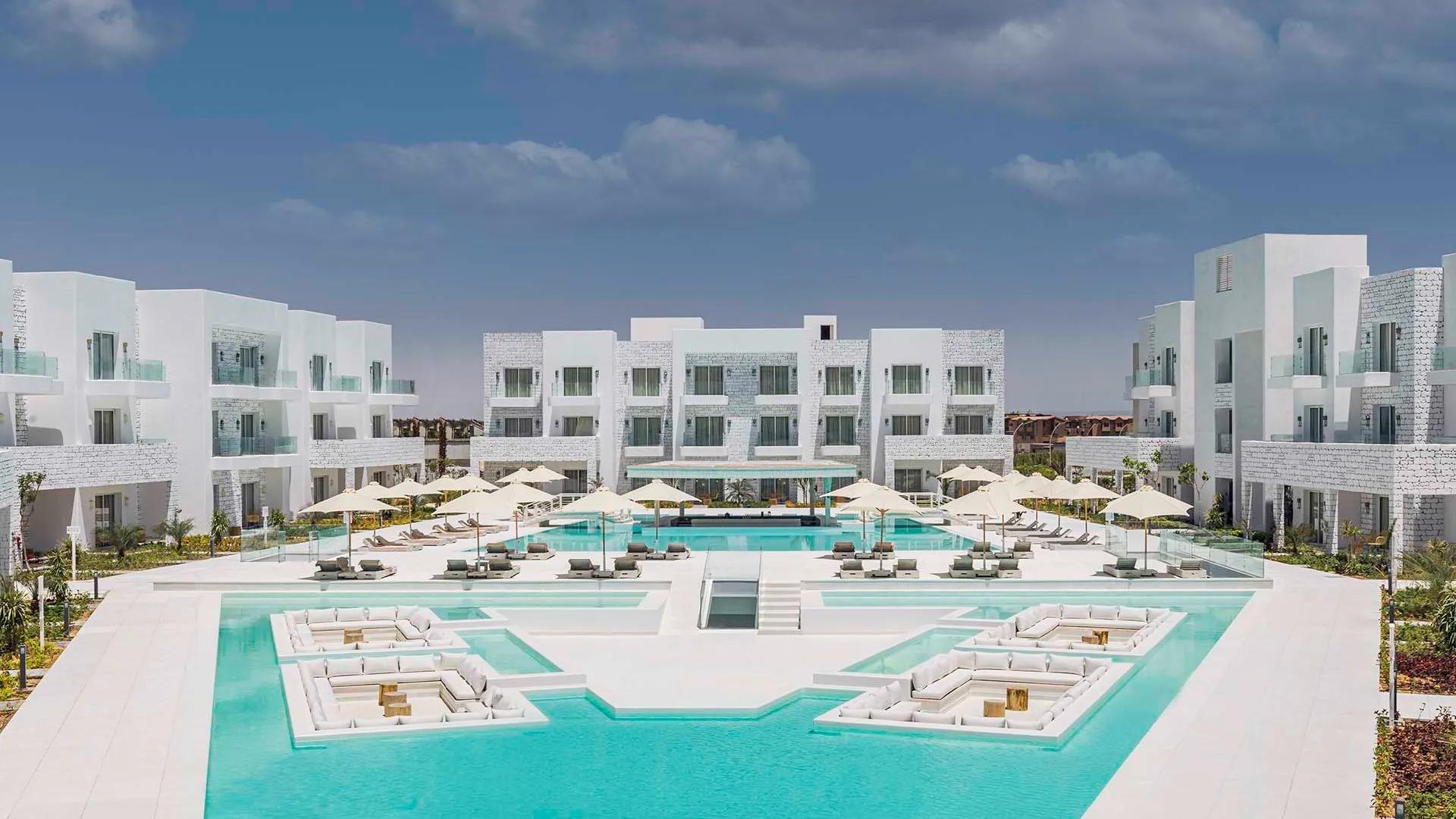 A Large Building With A Pool In Front Of It