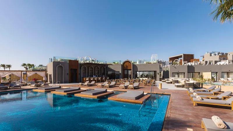 A Pool With A Building In The Background