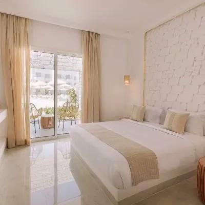 A Bedroom With A Large Window