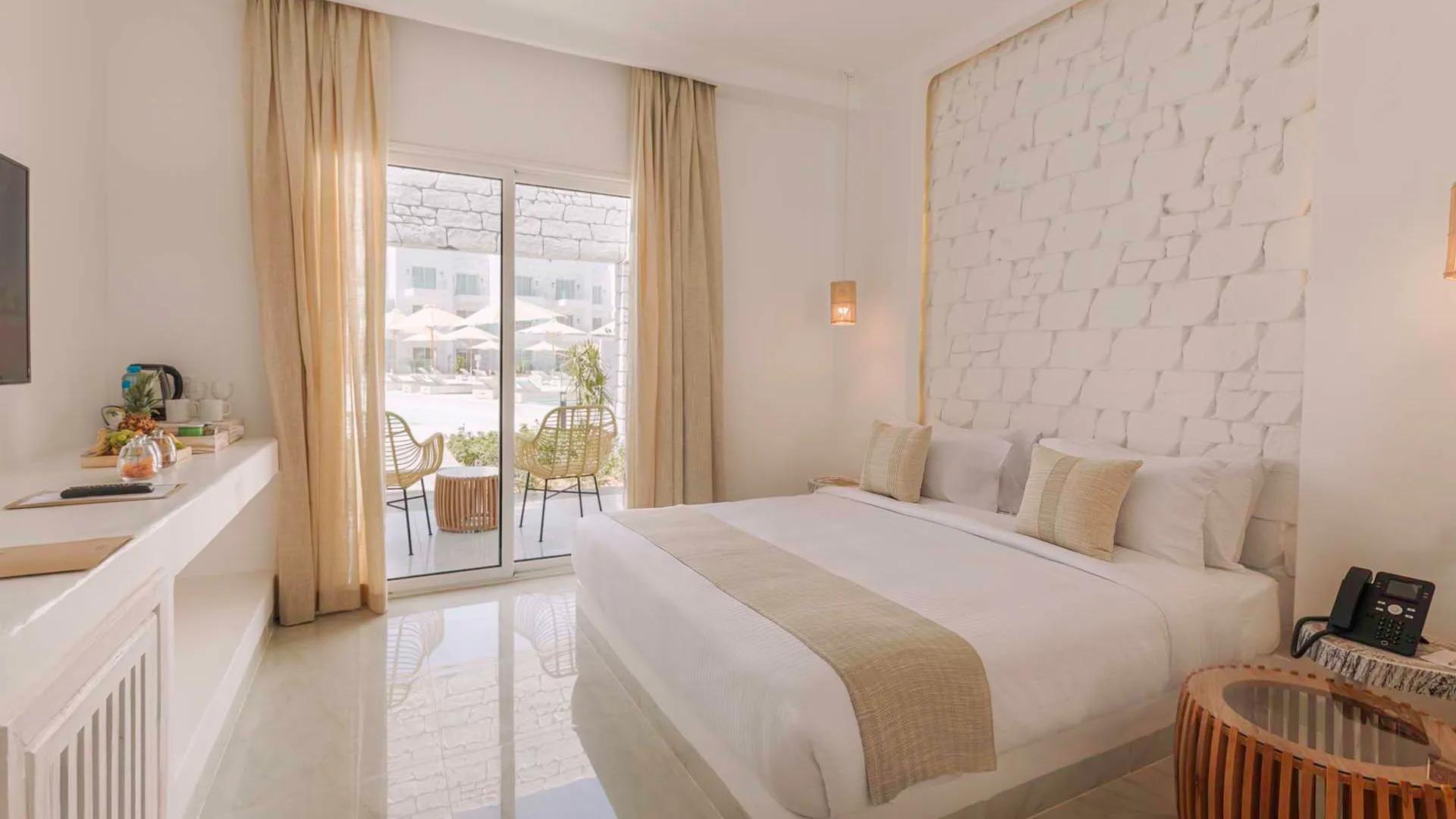 A Bedroom With A Large Window