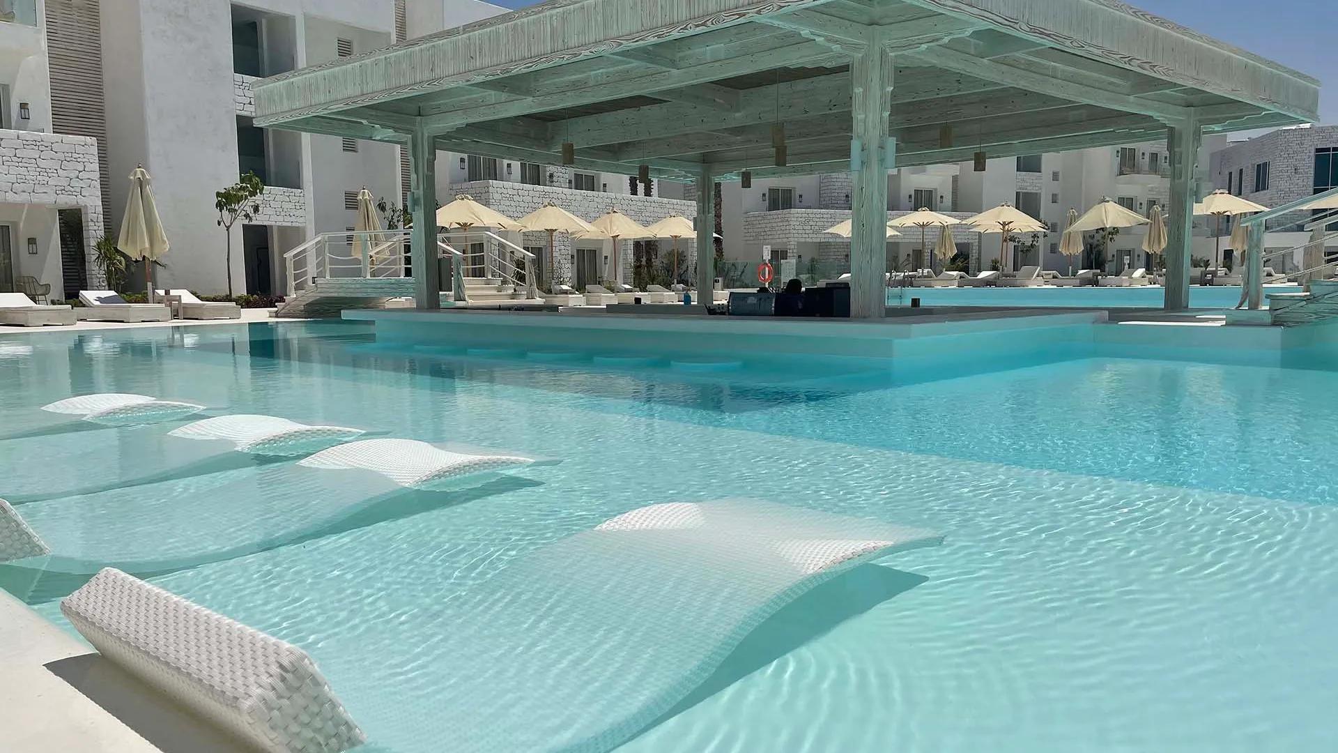 A Pool With A Building In The Background