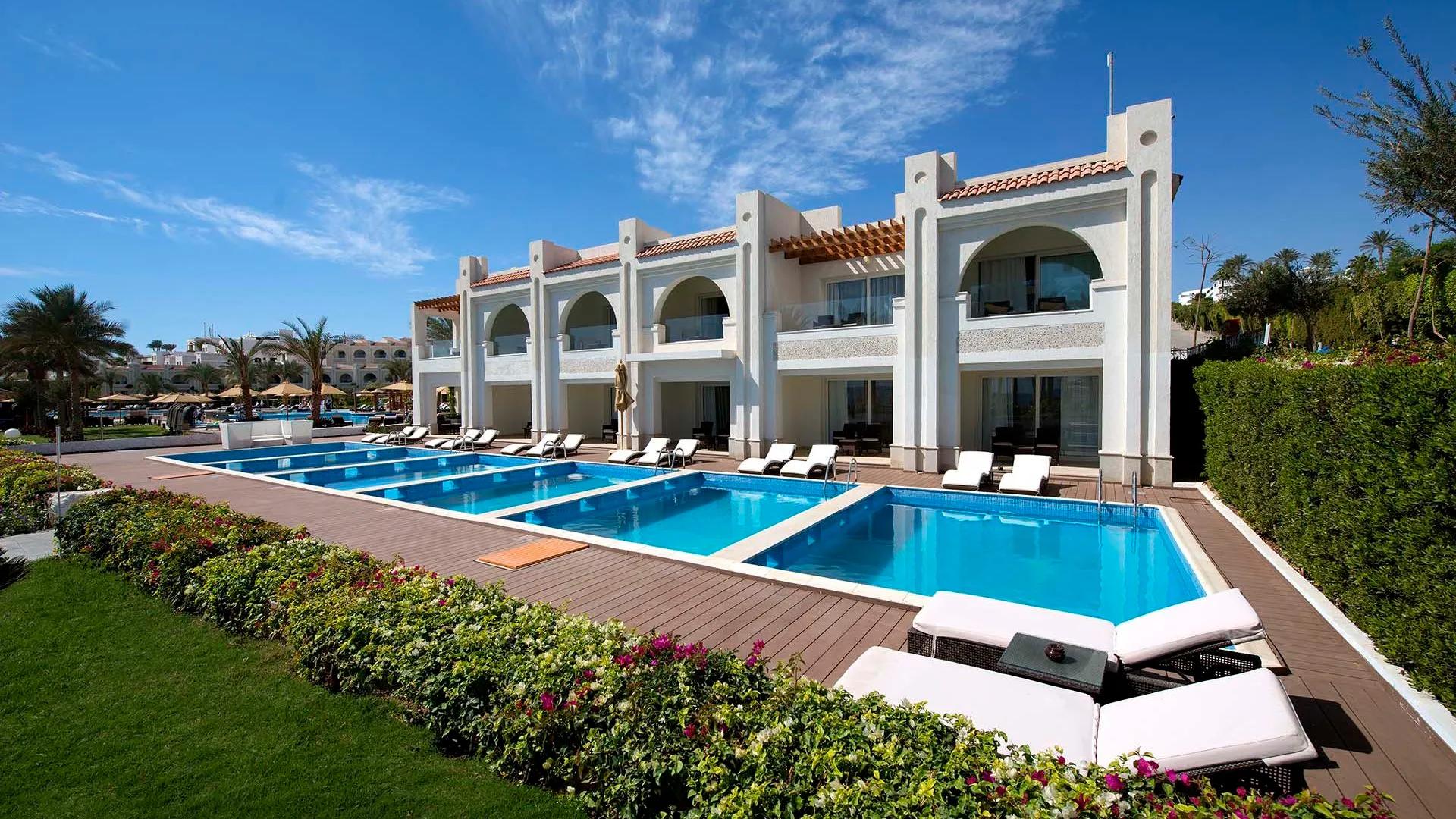 A Large White House With A Pool