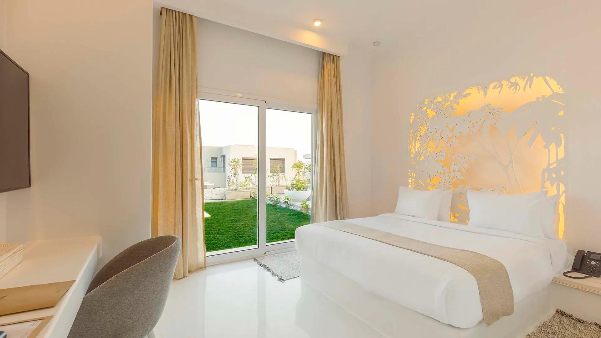 A Bedroom With A Large Window