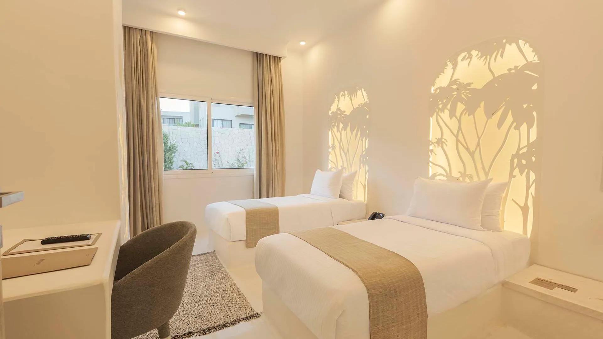 A Bedroom With A Large Window