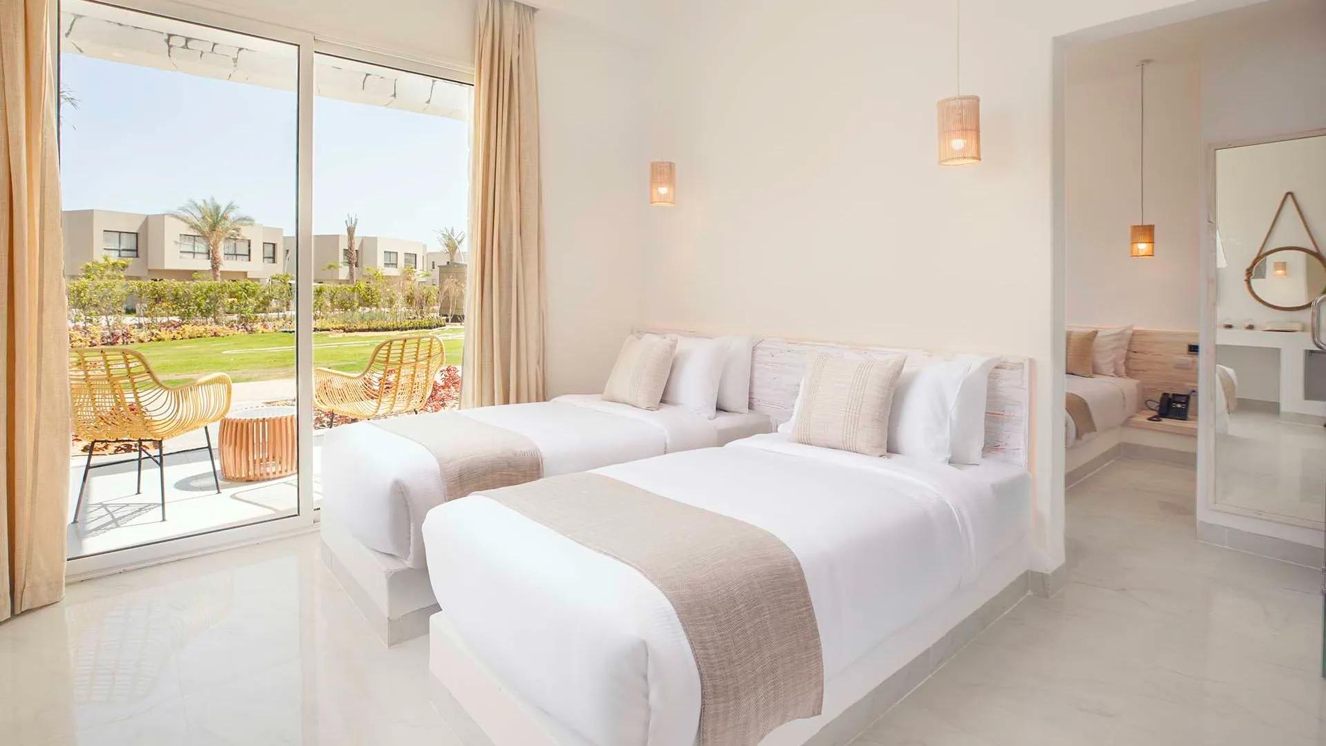 A Bedroom With A Large Window