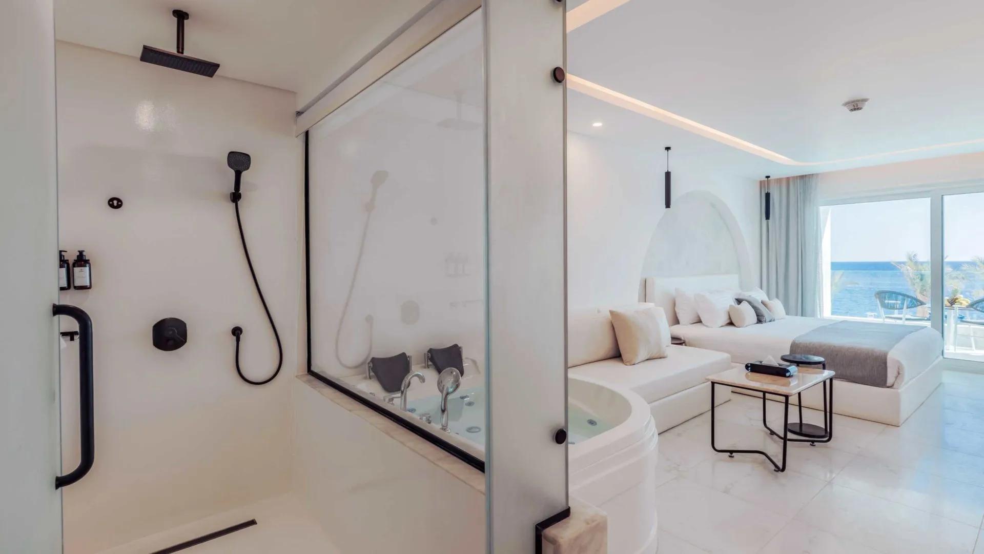 A Modern Bedroom With A Glass Shower
