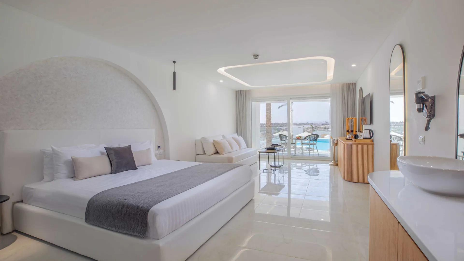 A Large Bedroom With A Large Bed