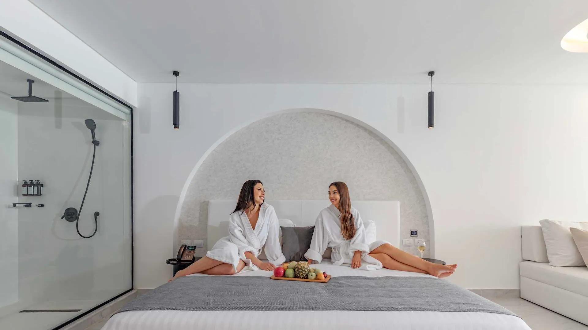 Two Women Sitting On A Bed