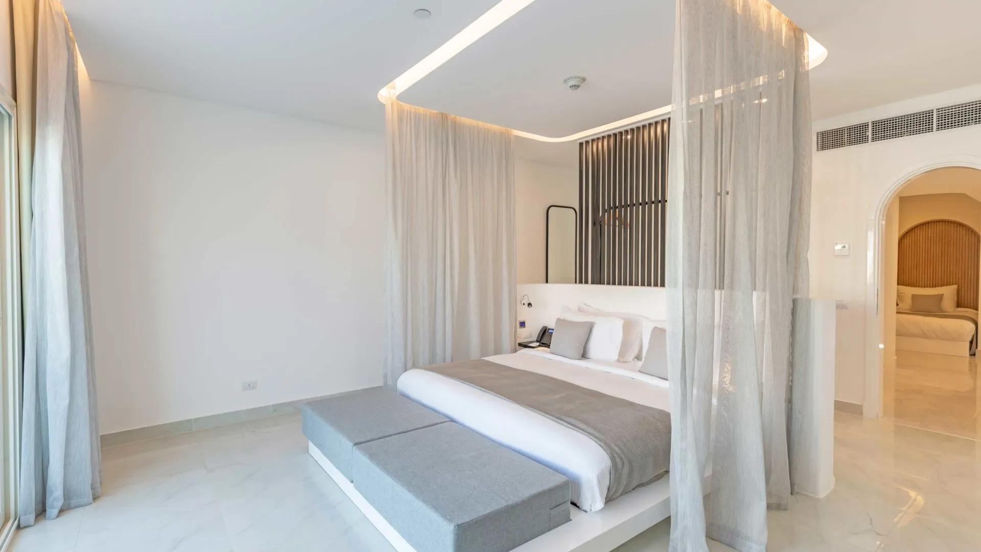 A Large Bedroom With A Large Bed