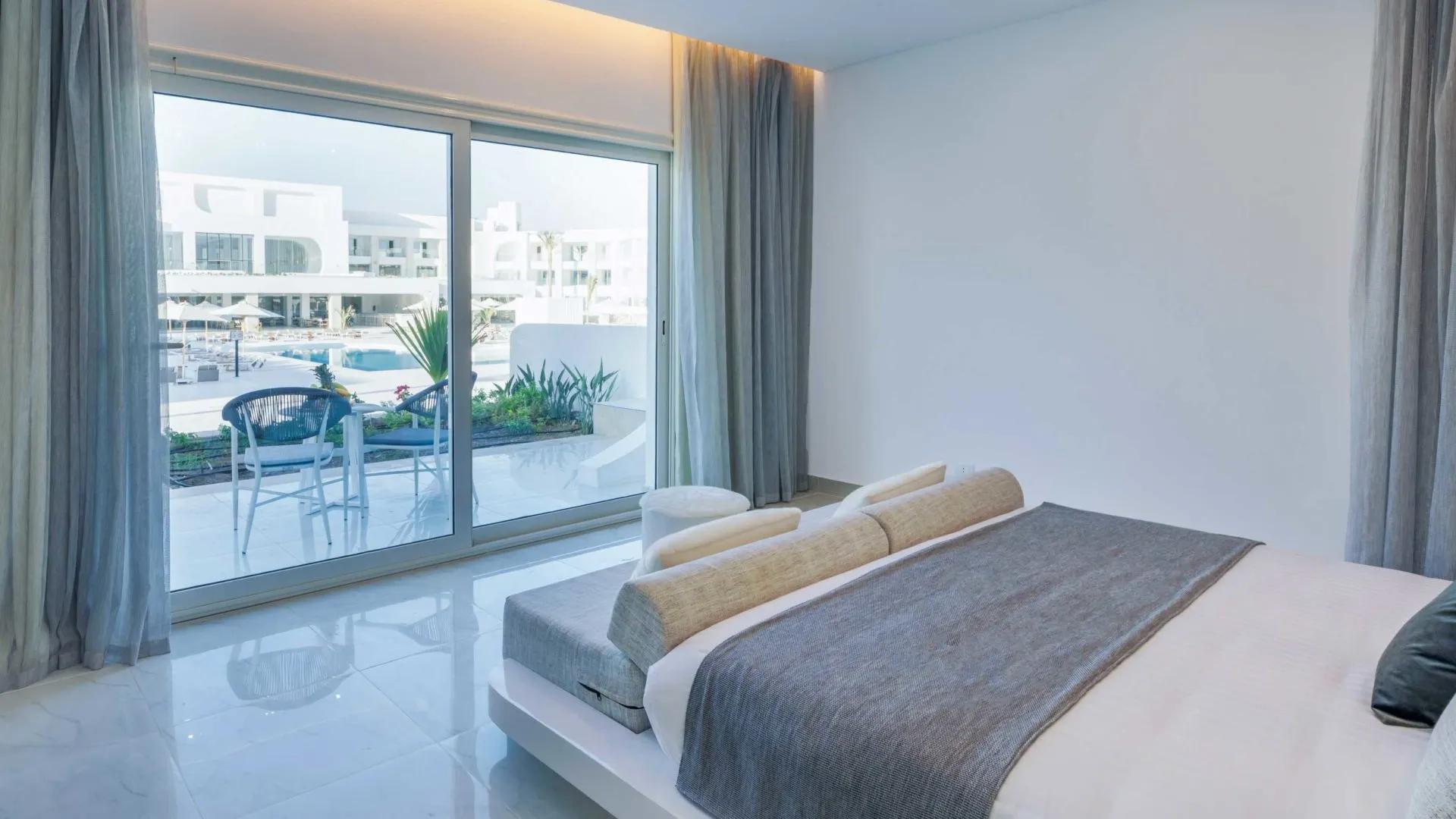 A Bedroom With A Large Window