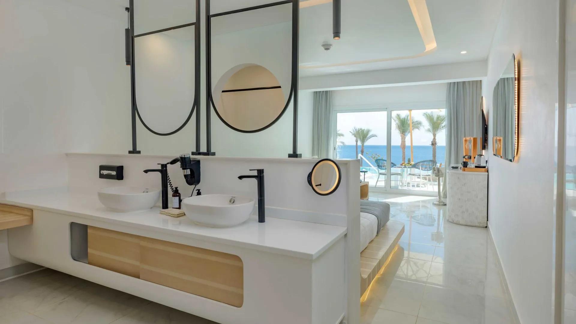 A Bathroom With A Large Mirror