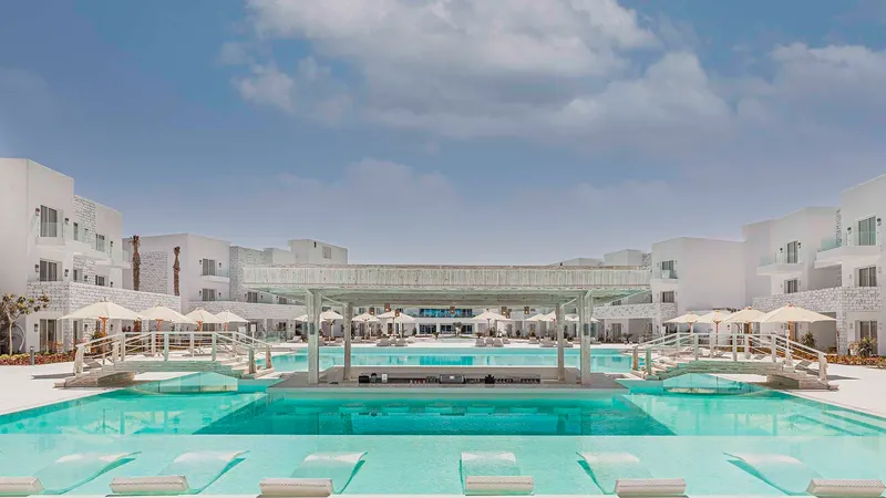 A Pool With A Building In The Background