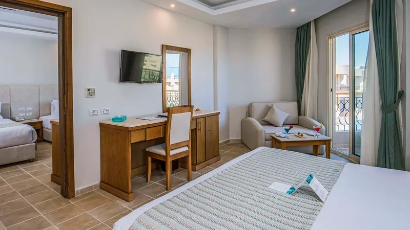 A Bedroom With A Bed Desk And Couches