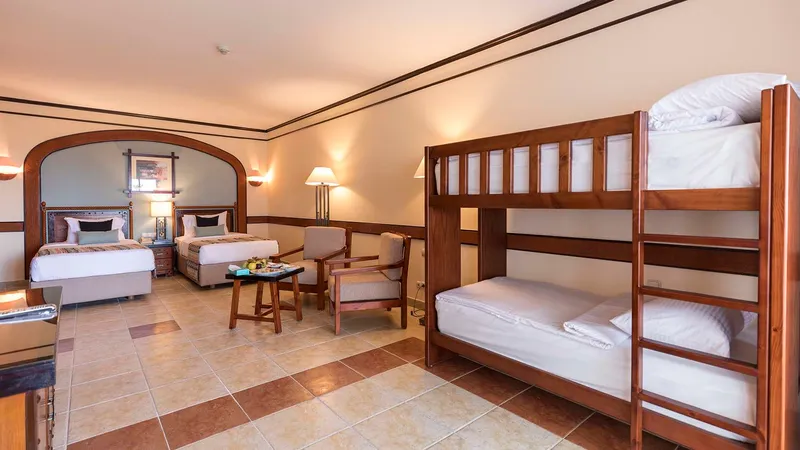 A Bedroom With A Bed And A Mirror
