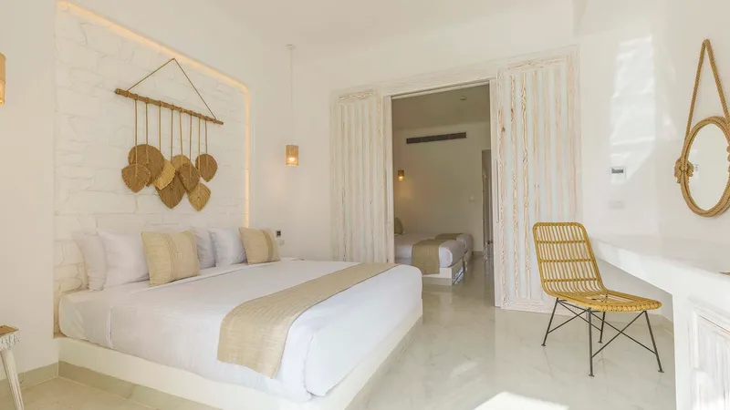 A Bedroom With A Bed And A Chair
