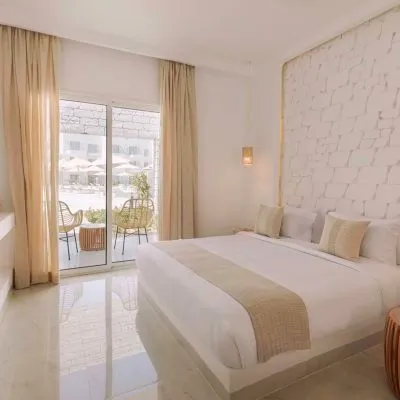 A Bedroom With A Large Window